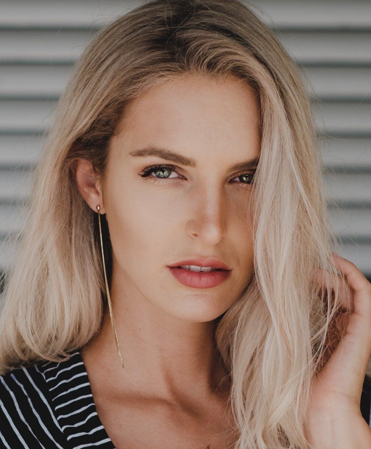 Woman with long blonde hair and striking features